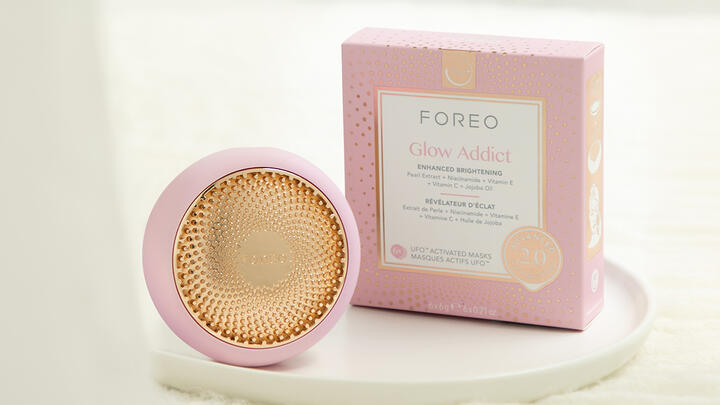 FOREO UFO 2 device in pearl pink together with a FOREO facial mask